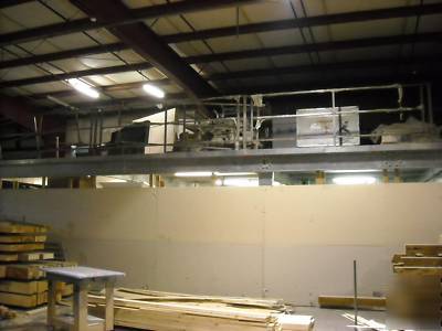 Industrial mezzanine structure with railing and roof